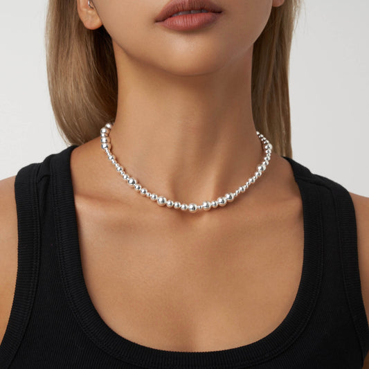 Big silver beads and small silver beads strung this sparkling necklace, whether it is paired with a T-shirt or a formal dress, it will make you the most shining star in the crowd.